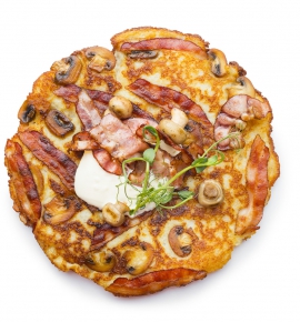 Potato pancake with baked-in champignons and fried bacon